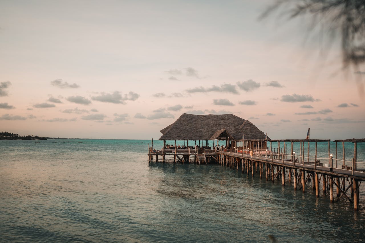 Scenic pier extending into the Indian Ocean at sunset, capturing the serene beauty of Zanzibar.