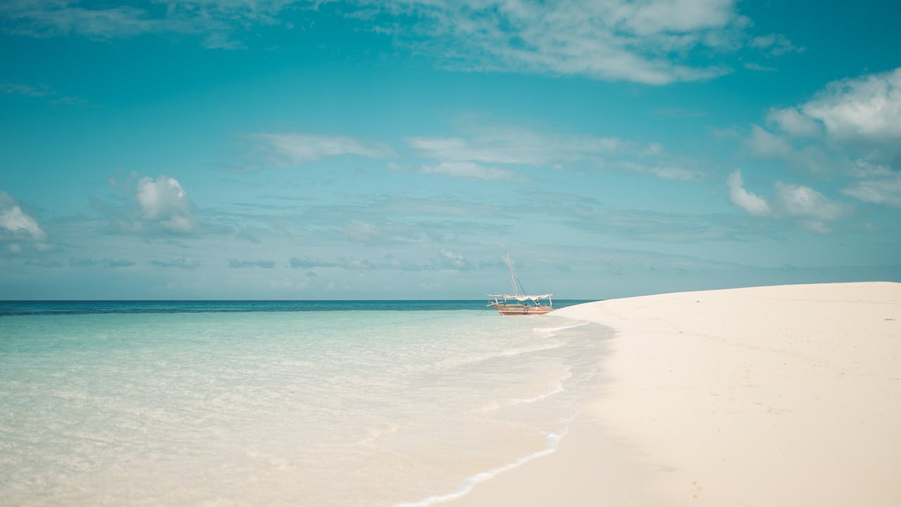 Explore the serene white sands and blue waters of Zanzibar's pristine beach.