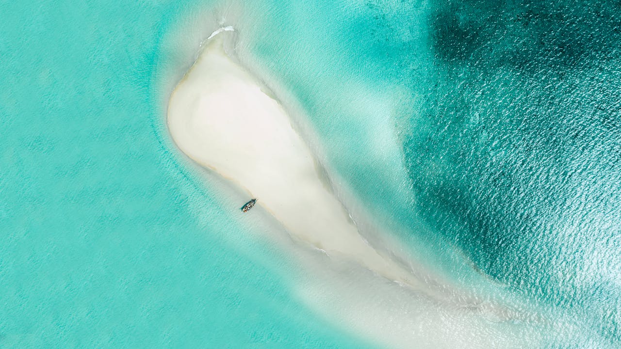 Stunning aerial view of a sandbar surrounded by turquoise waters in Zanzibar, Tanzania.
